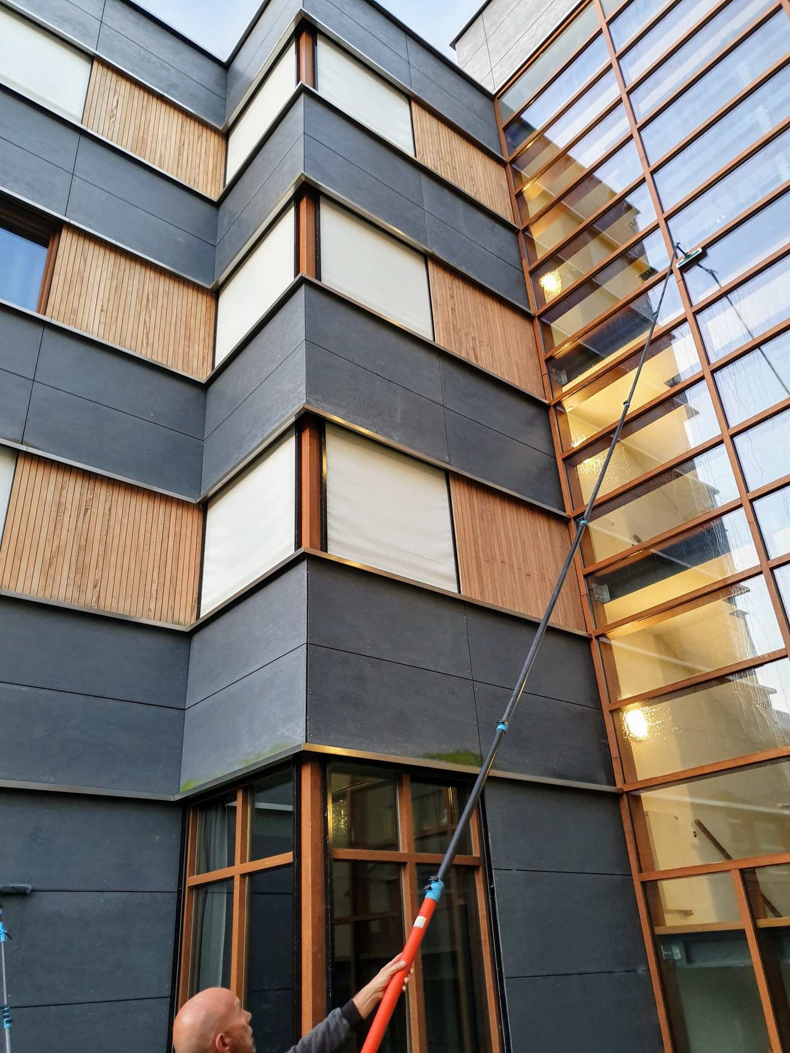 Gevelbekleding die met een telescoopstang gereinigd wordt